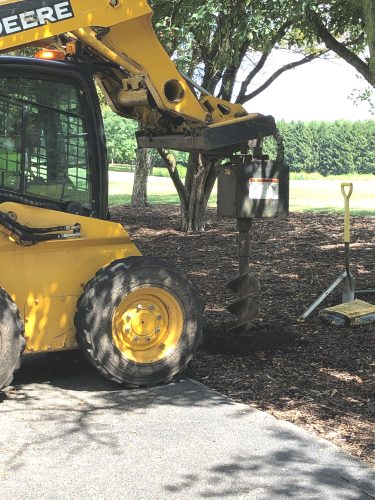 Auger attachment on digging machinery